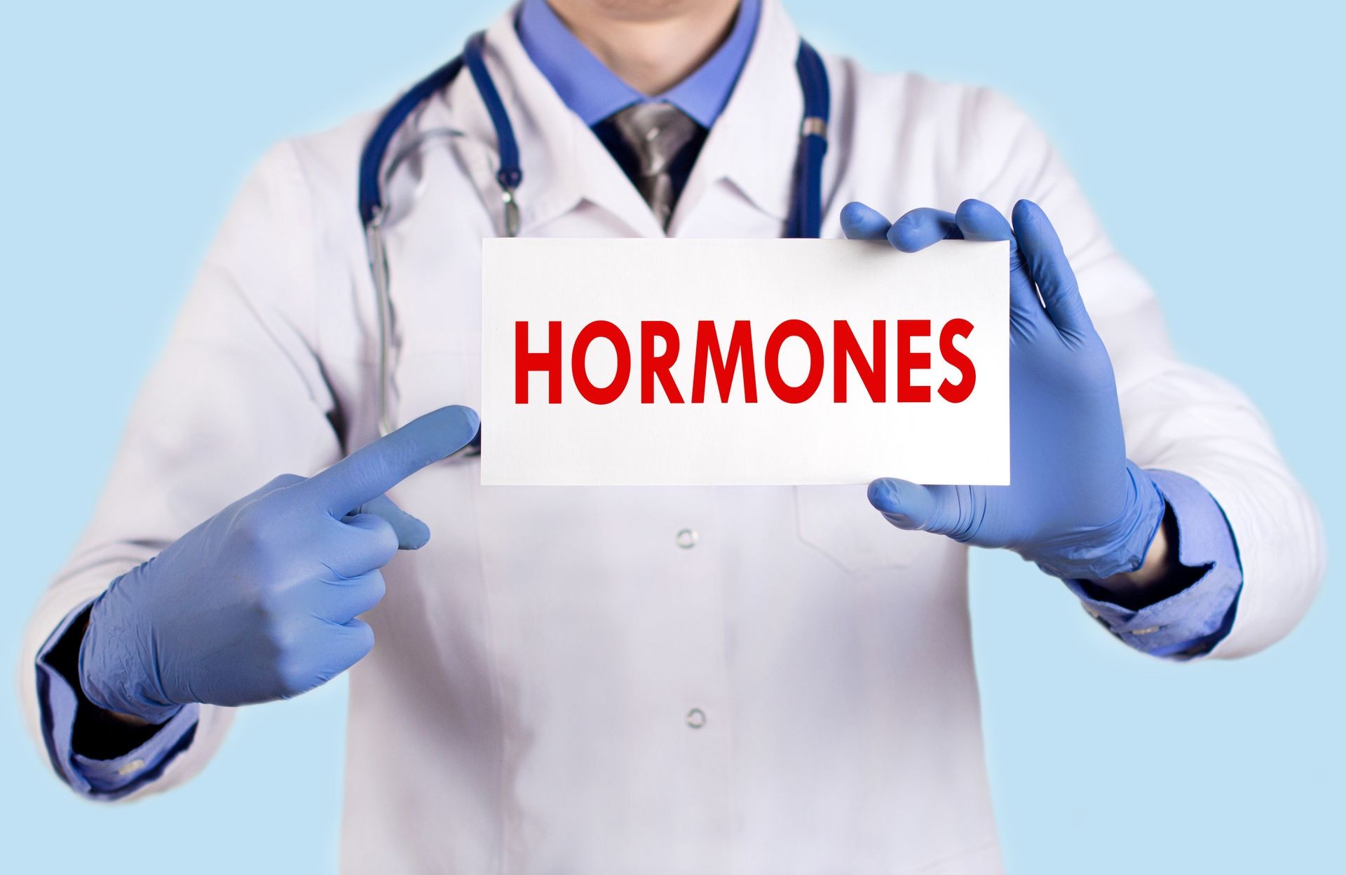 Doctor keeps a card with the name of the hormones. Selective focus. Medical concept.